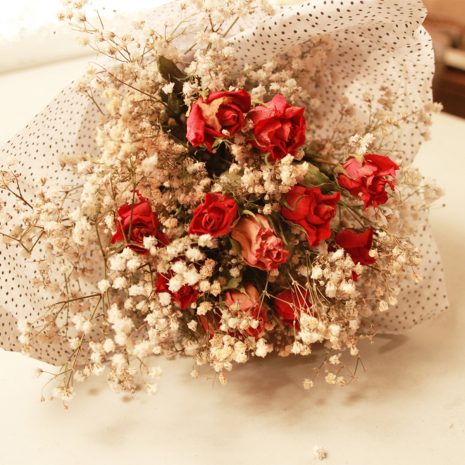 Red-Rose-Bouquet-Front-Full Close up Front view of Dried Red Roses Bouquet wrapped in tissue paper and tied with silk bow from Silver Acres